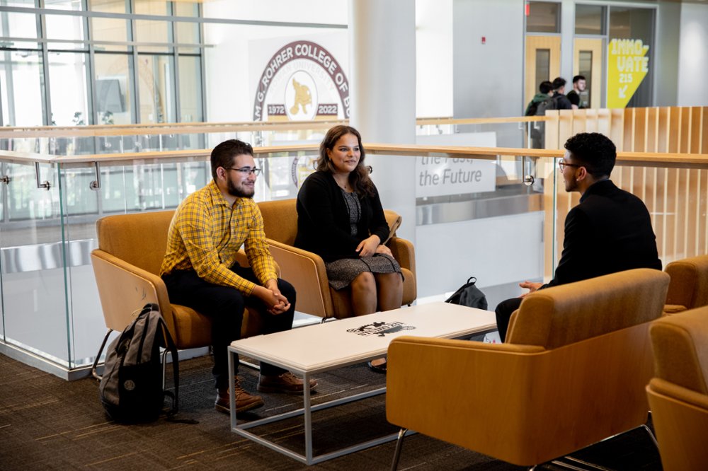 Various individuals having a discussion in one of the academic buildings on Rowan's campus.