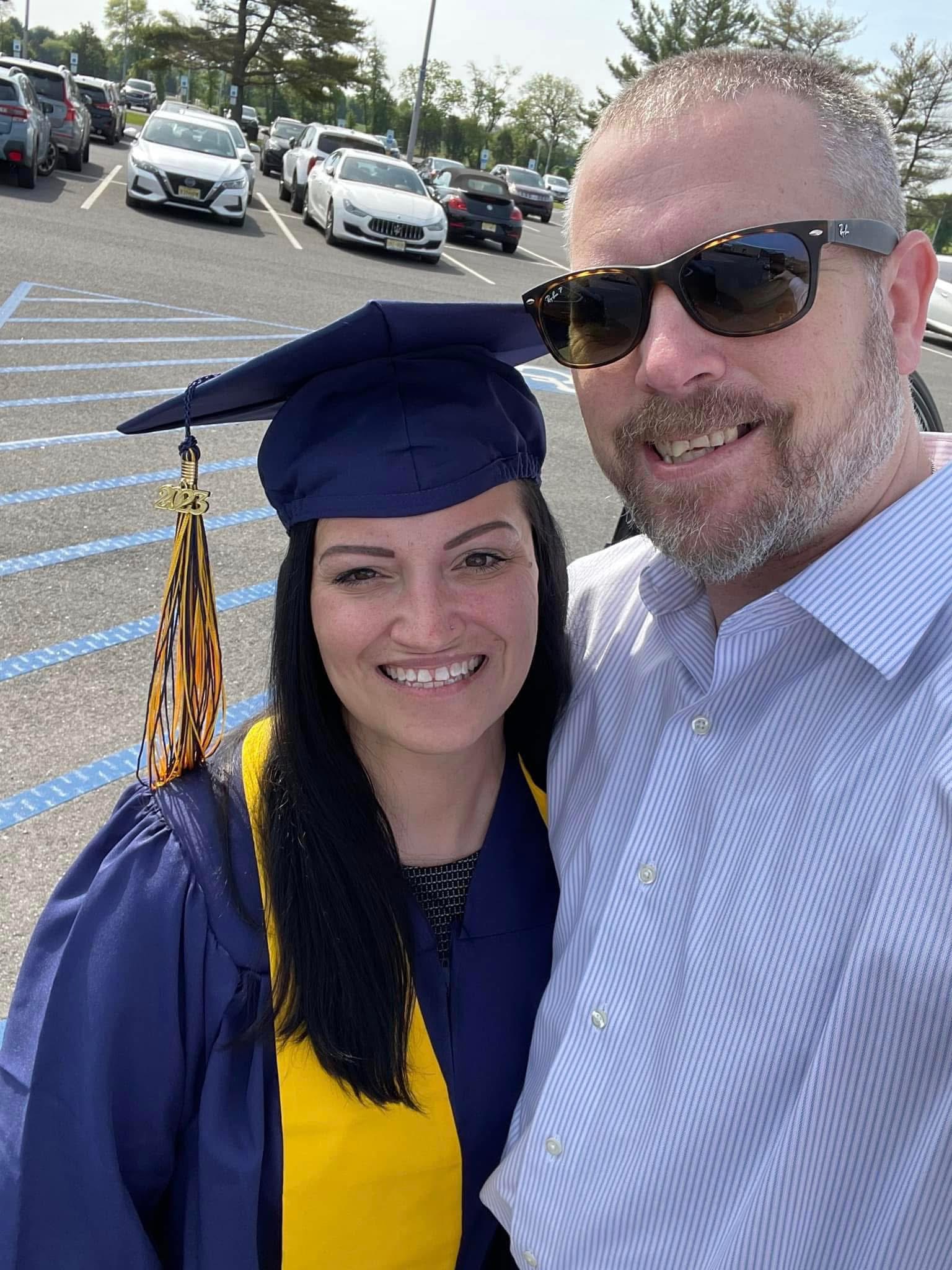 Shannon C. poses for a selfie in her graduation cap and gown.
