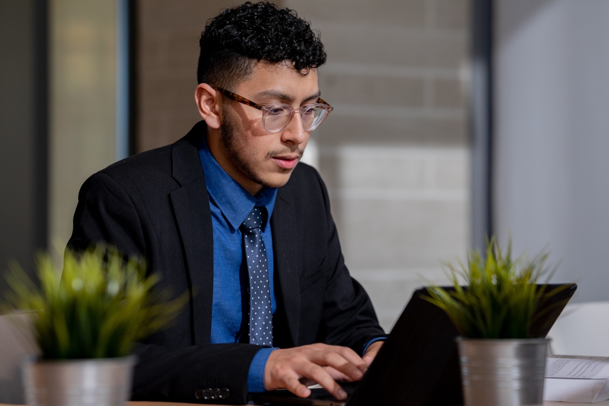 A Rowan student works on their laptop.