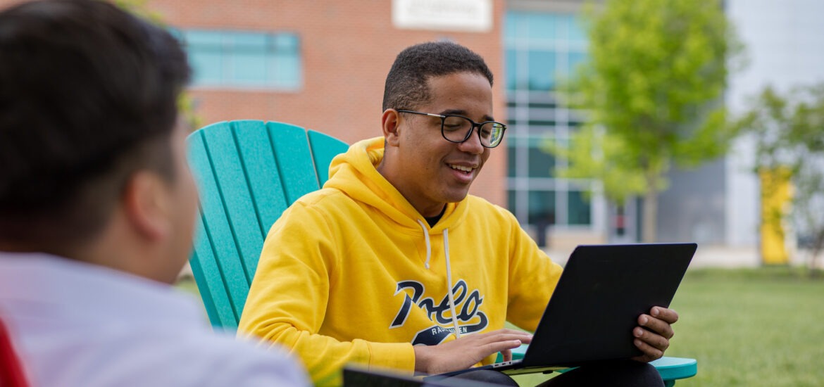 A student works on a laptop.
