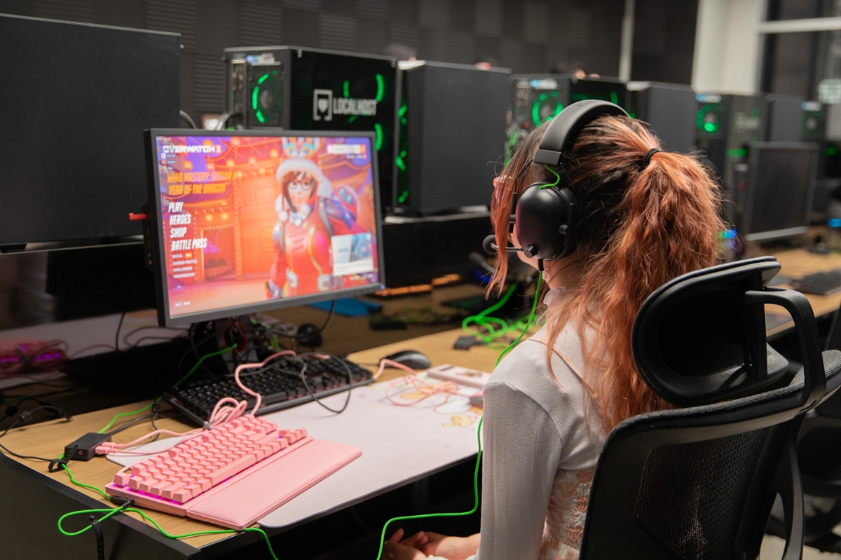 A student sits at their computer while gaming.
