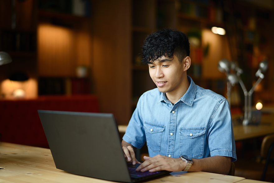 A student works on their laptop.