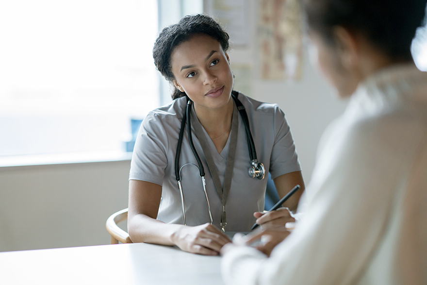 A medical professional speaks with a patient.