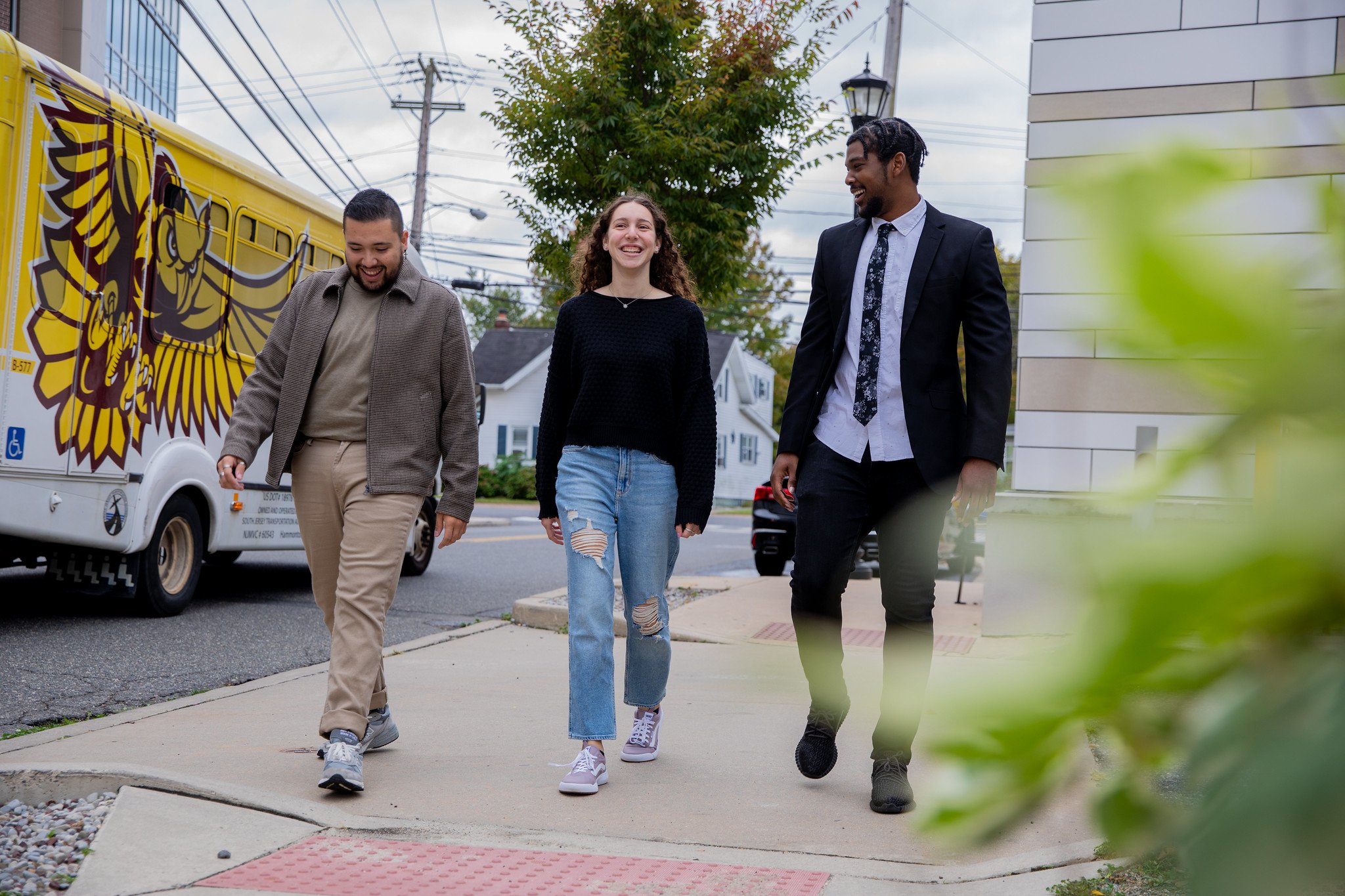 Rowan University student Gabby walks with two friends past the Rowan shuttle.